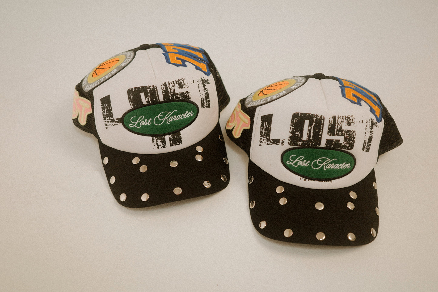 LOST LOGO MULTI PATCH TRUCKER HAT