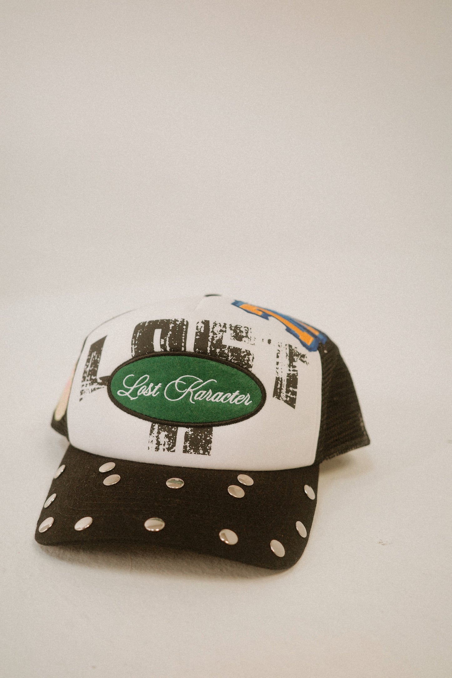 LOST LOGO MULTI PATCH TRUCKER HAT